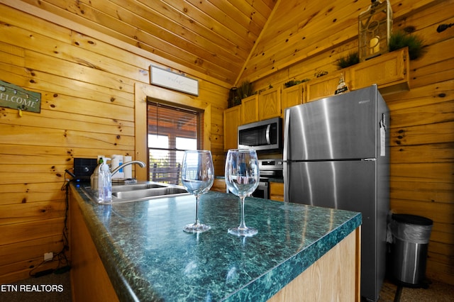 936 Buck Way, Sevierville, TN 37876 - kitchen with wooden walls, dark countertops, appliances with stainless steel finishes, and a sink