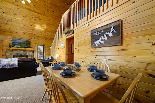 936 Buck Way, Sevierville, TN 37876 - carpeted dining area featuring a fireplace, wooden walls, and high vaulted ceiling