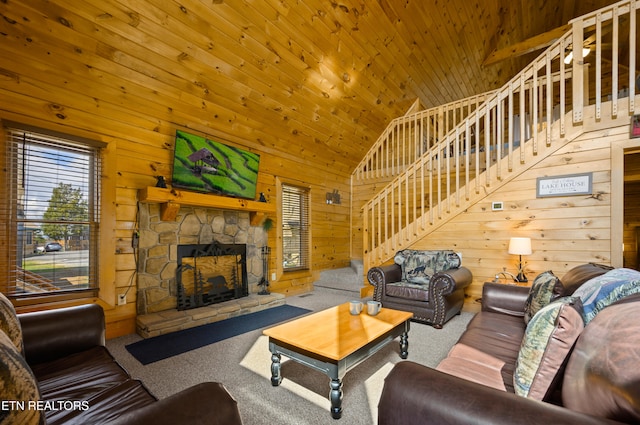 936 Buck Way, Sevierville, TN 37876 - carpeted living area featuring wood walls, stairs, a stone fireplace, high vaulted ceiling, and wood ceiling