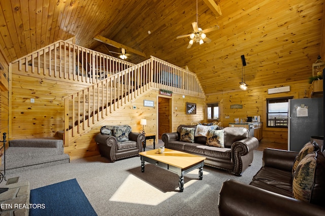 936 Buck Way, Sevierville, TN 37876 - carpeted living room with wooden walls, high vaulted ceiling, ceiling fan, and stairs