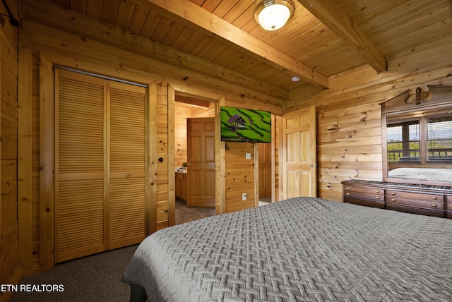 936 Buck Way, Sevierville, TN 37876 - bedroom with wood walls, beam ceiling, wooden ceiling, carpet floors, and a closet