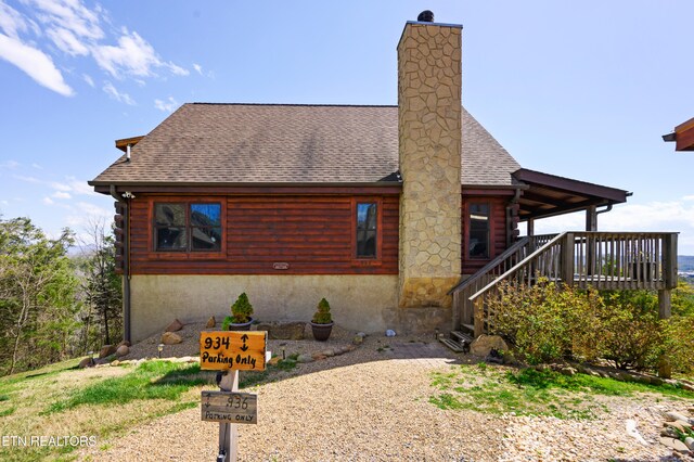 936 Buck Way, Sevierville, TN 37876 - exterior space with a shingled roof, a chimney, and log siding