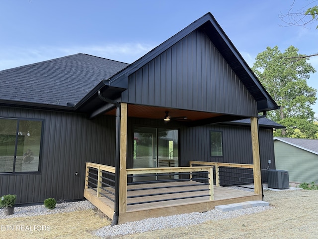 view of front of property featuring a shingled roof, a ceiling fan, and cooling unit