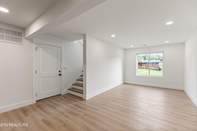 below grade area featuring visible vents, baseboards, stairway, recessed lighting, and light wood-type flooring