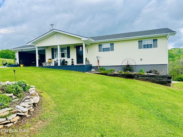 ranch-style home featuring covered porch and a front yard