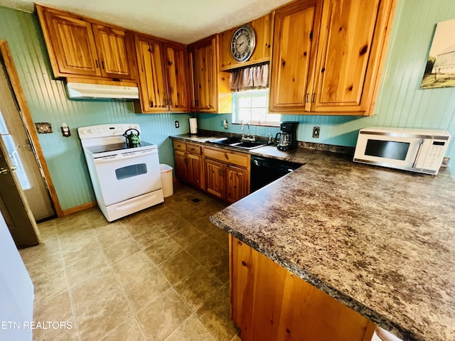 kitchen featuring white appliances, brown cabinetry, and under cabinet range hood