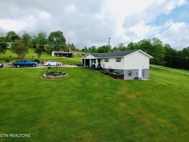 back of property featuring a lawn