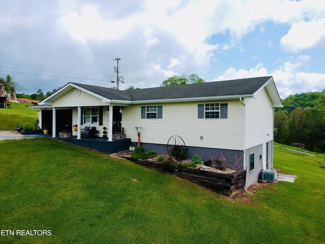 single story home with cooling unit, a front lawn, a garage, and a porch