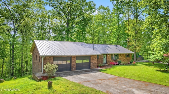 single story home featuring a garage, a front yard, driveway, and brick siding