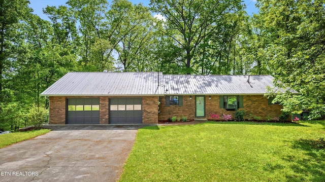 single story home with concrete driveway, a front lawn, brick siding, metal roof, and an attached garage