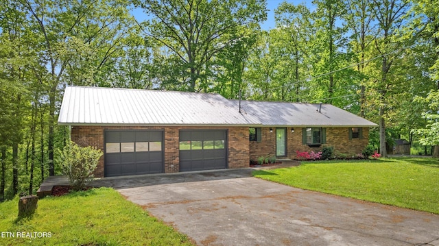 ranch-style house featuring aphalt driveway, metal roof, a garage, brick siding, and a front lawn
