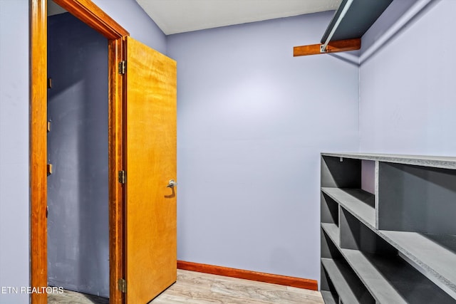 walk in closet featuring light wood finished floors