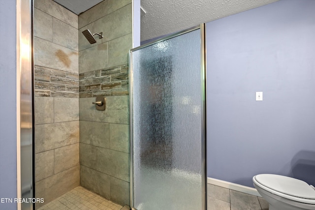 bathroom with tile patterned flooring, a stall shower, and toilet