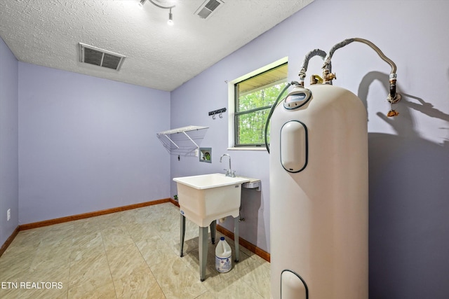 office featuring a textured ceiling, visible vents, and baseboards