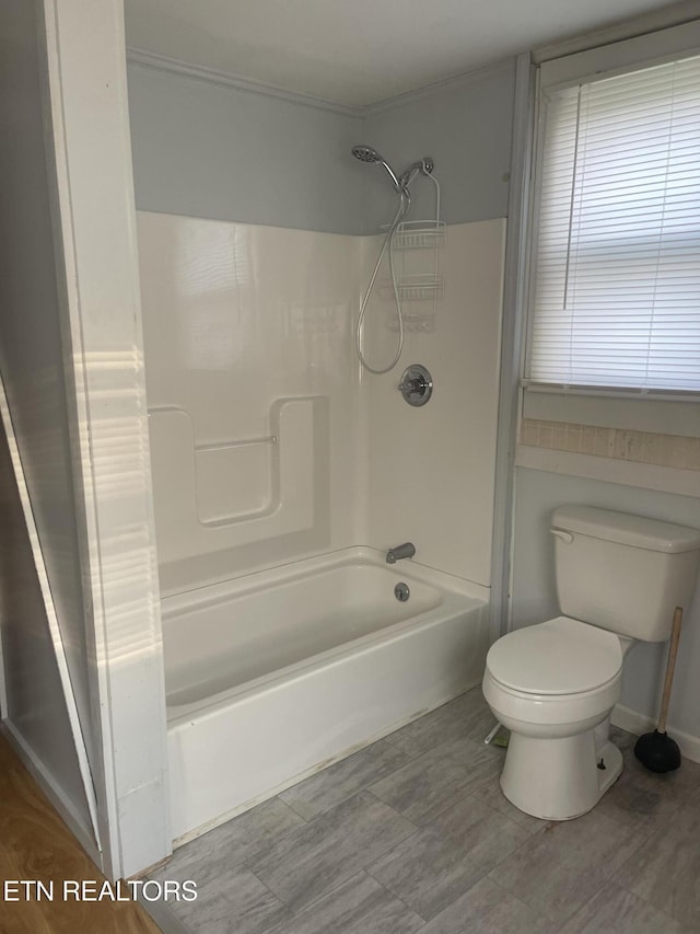 full bath with washtub / shower combination and toilet