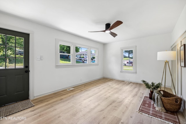foyer with light wood-style floors, visible vents, baseboards, and a ceiling fan