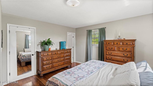 bedroom featuring dark wood-style flooring