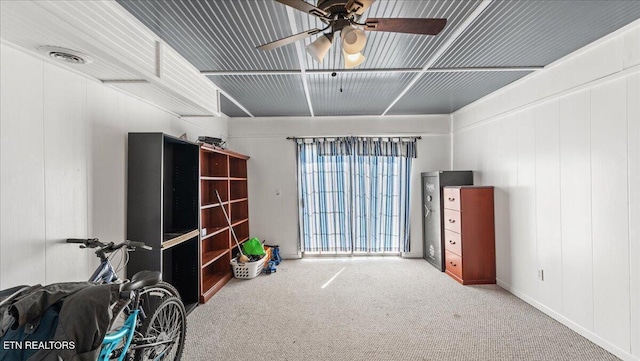 interior space featuring visible vents, carpet, and ceiling fan