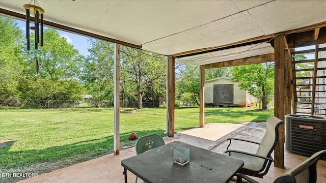 view of patio / terrace with central AC, an outbuilding, a fenced backyard, and a storage shed