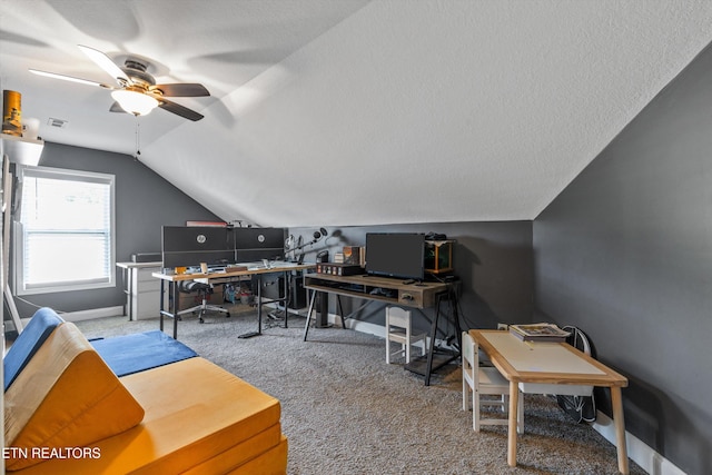 carpeted office featuring a ceiling fan, vaulted ceiling, and baseboards