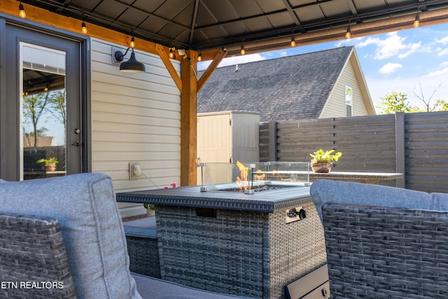 view of patio featuring fence and a gazebo