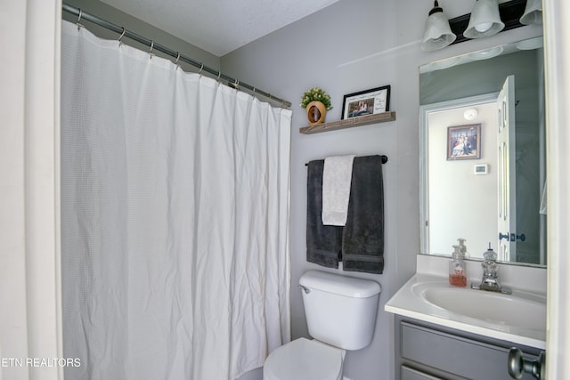 full bathroom with toilet and vanity