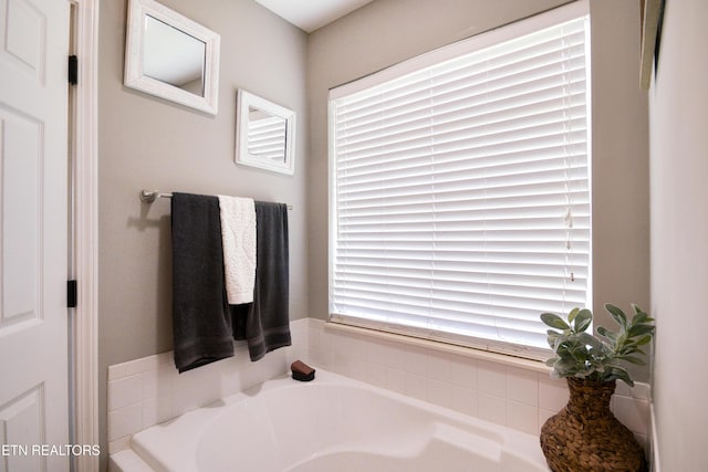 bathroom with a bath and a wealth of natural light