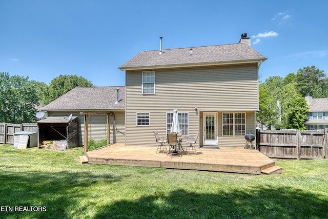 back of property featuring a shed, a wooden deck, a fenced backyard, and a chimney