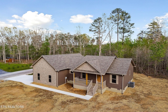 view of front of home featuring a porch, central AC unit, roof with shingles, and crawl space