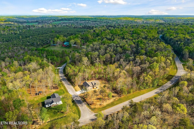 aerial view featuring a wooded view