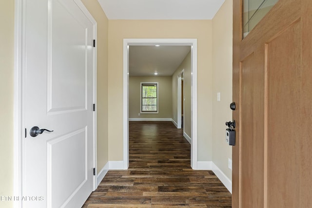 hall with baseboards and dark wood-style floors