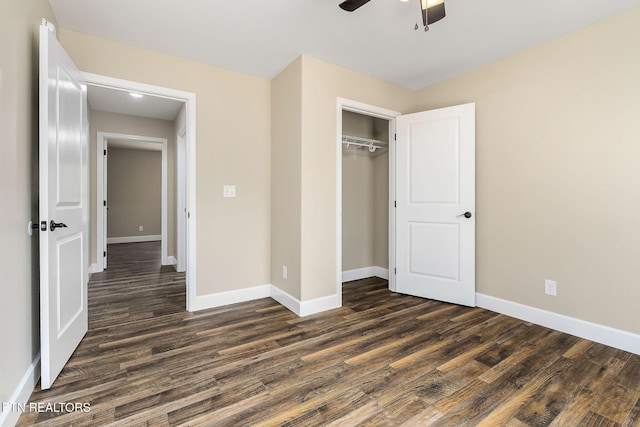 unfurnished bedroom featuring baseboards, a ceiling fan, a closet, and dark wood-style flooring