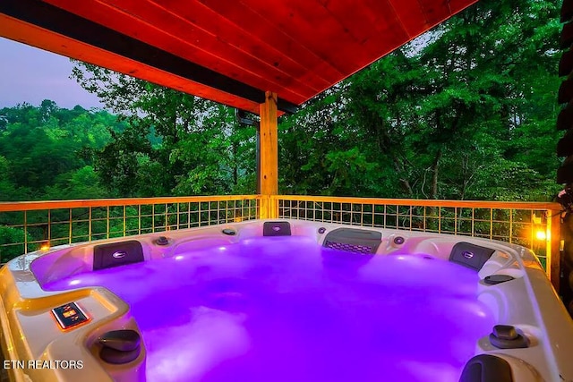 exterior space featuring washer / clothes dryer and a hot tub