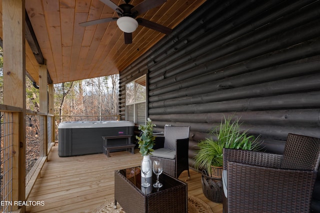 wooden deck with ceiling fan and a hot tub