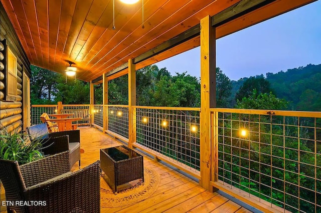 wooden terrace featuring an outdoor living space