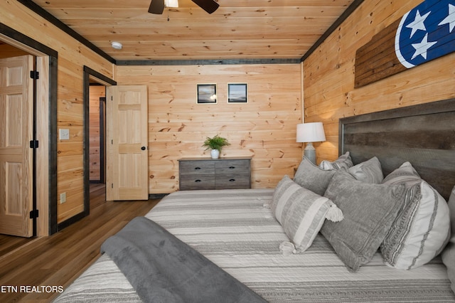 bedroom featuring wood walls, wooden ceiling, and wood finished floors