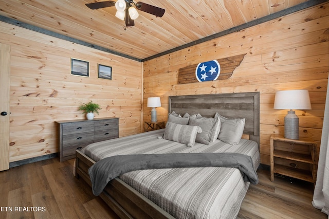 bedroom featuring wooden ceiling, wood walls, and wood finished floors