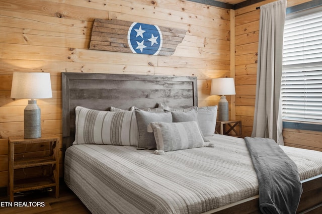 bedroom with wood walls
