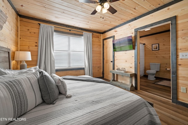bedroom with wooden walls, wooden ceiling, and wood finished floors