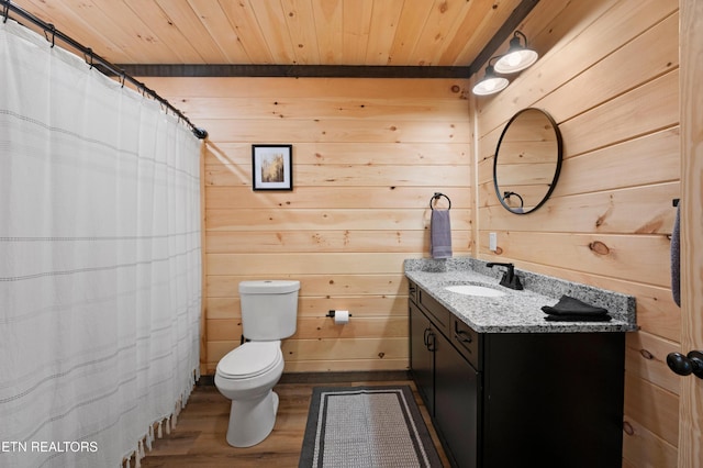 full bathroom with vanity, wood finished floors, toilet, wooden walls, and wooden ceiling