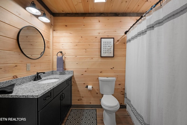 bathroom featuring wooden walls, wooden ceiling, and toilet