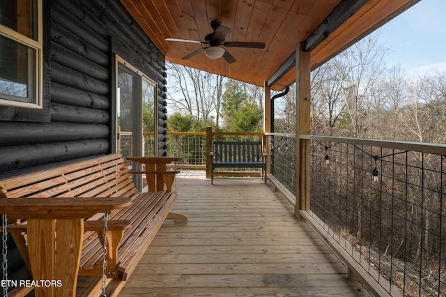wooden terrace featuring a ceiling fan