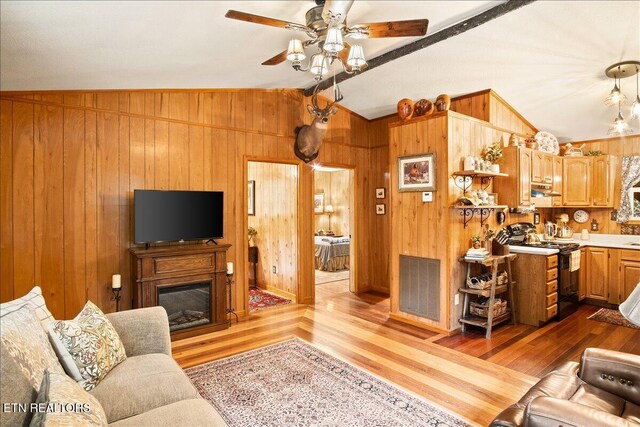 3009 Winding Way, Cosby, TN 37722 - living area with wood finished floors, a ceiling fan, wooden walls, and a fireplace