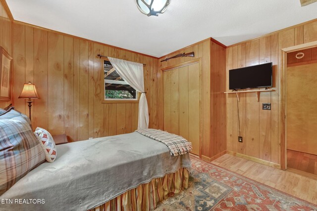 3009 Winding Way, Cosby, TN 37722 - bedroom featuring wood finished floors, wood walls, and a closet