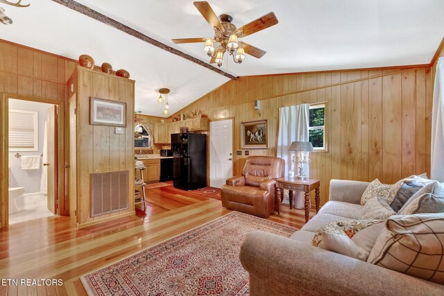 3009 Winding Way, Cosby, TN 37722 - living area featuring wooden walls, light wood-style flooring, vaulted ceiling, and a ceiling fan