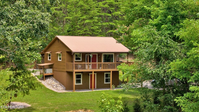 3009 Winding Way, Cosby, TN 37722 - back of house featuring a lawn, a deck, a metal roof, and a forest view