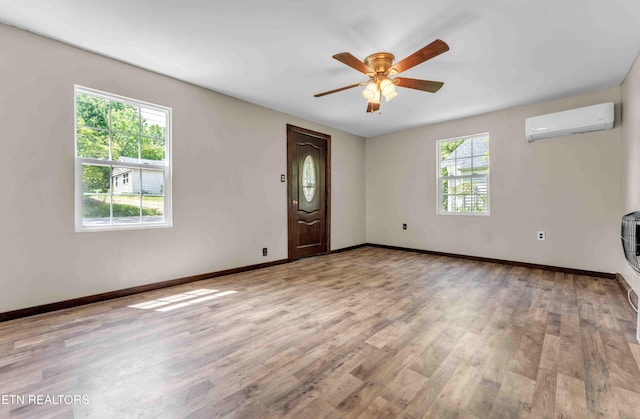 1526 W View St, Athens, TN 37303 - unfurnished living room featuring baseboards, a wall unit AC, a ceiling fan, and wood finished floors