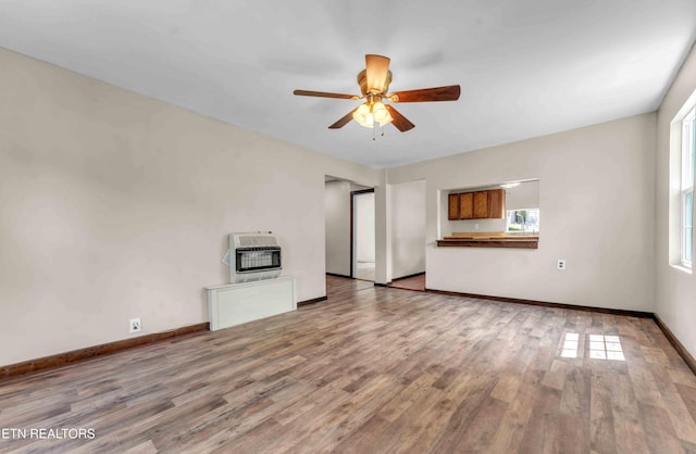 1526 W View St, Athens, TN 37303 - unfurnished living room featuring baseboards, heating unit, ceiling fan, and wood finished floors
