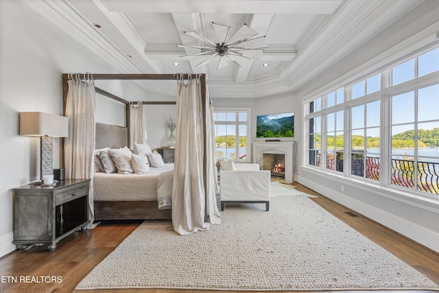 bedroom with crown molding, coffered ceiling, baseboards, and a lit fireplace