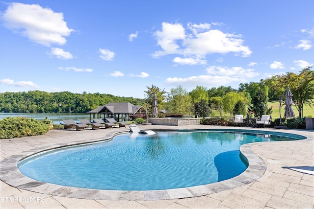 outdoor pool with a patio area